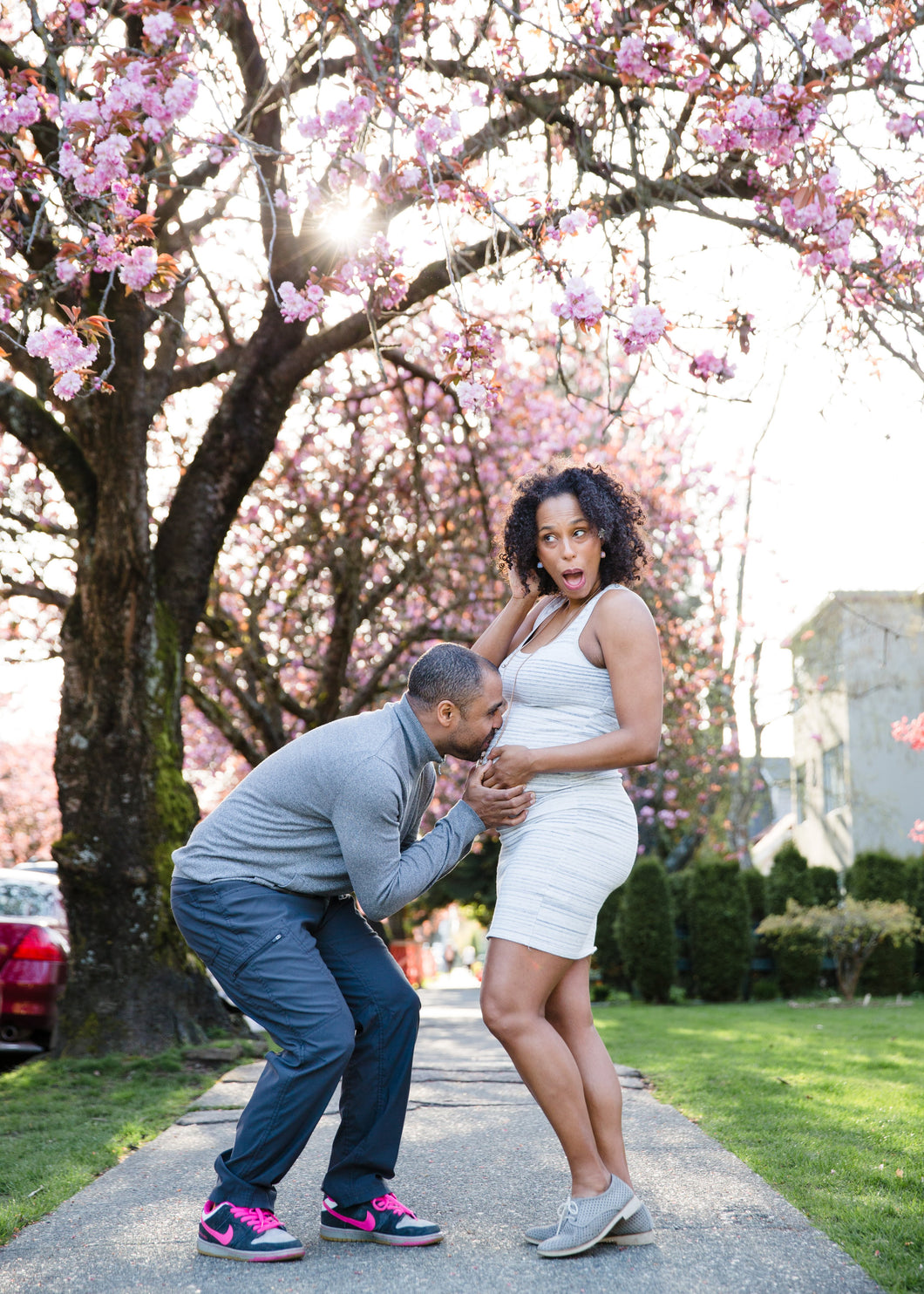 Dr. Holmes and Husband Pregnant with first child under cherry blossom tree - Spring